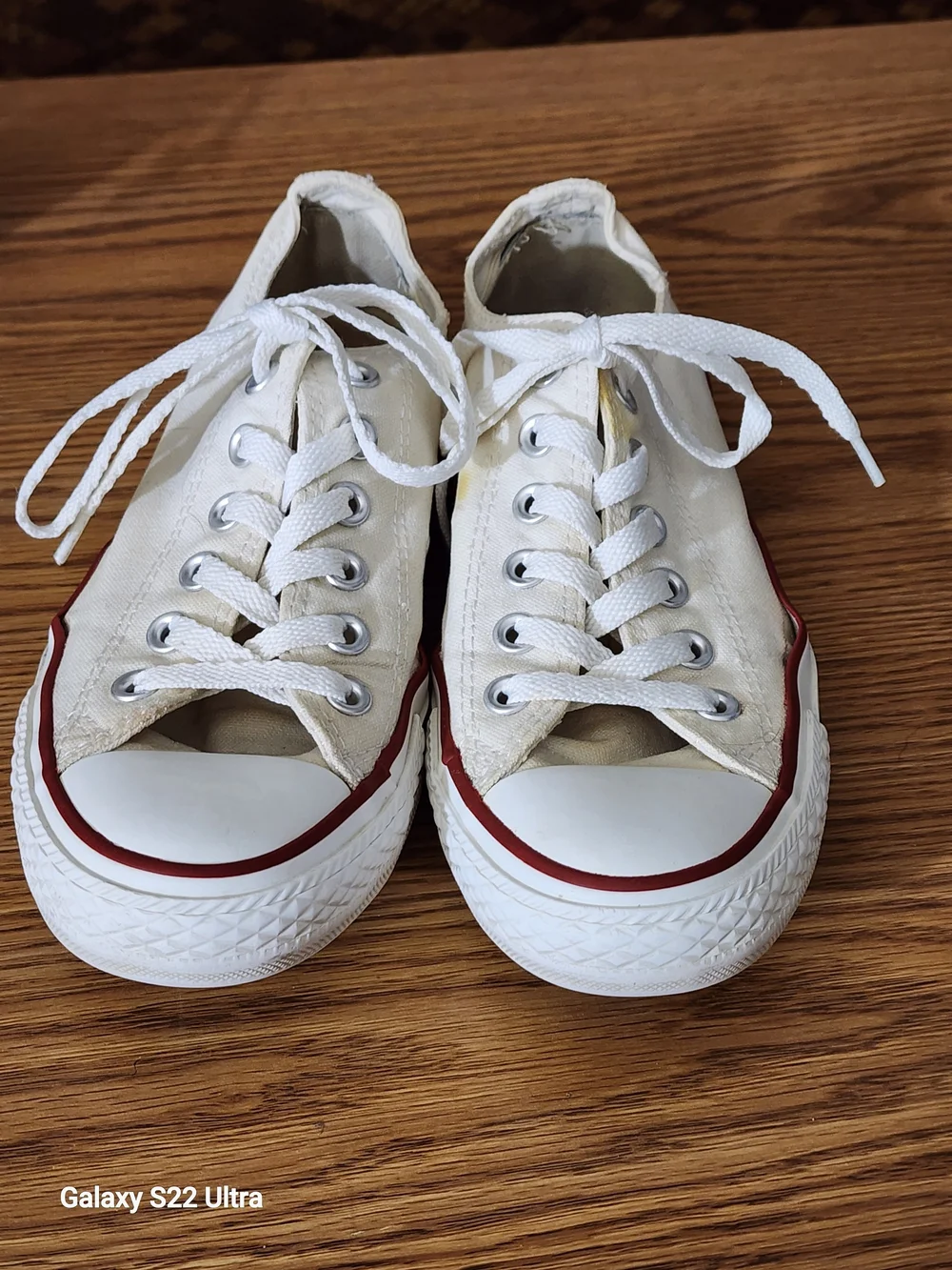 These are Converse Chuck Taylor All Star Low top sneakers in white canvas.